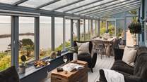 Inside, stunning interiors await, with two exquisite bedrooms in the main house and a further bedroom with en suite bathroom in the former artist's studio with jaw-dropping sea views