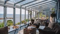 Inside, stunning interiors await, with two exquisite bedrooms in the main house and a further bedroom with en suite bathroom in the former artist's studio with jaw-dropping sea views