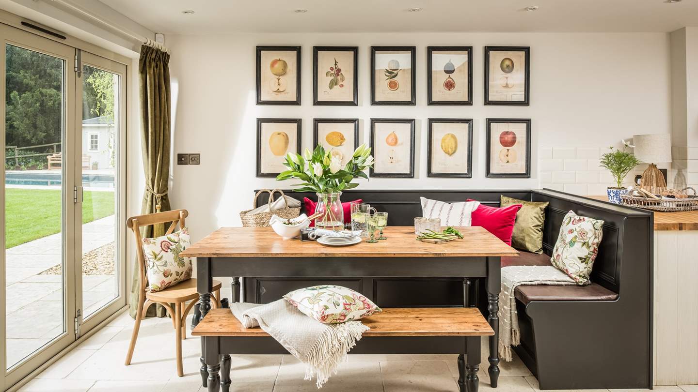 The informal dining area enjoys lovely views out over the garden