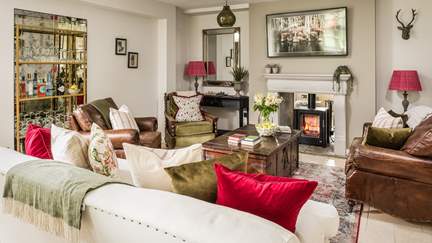 The gorgeously cosy sitting room with flickering woodburner