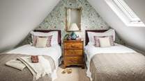 The oh-so-sweet twin bedroom set amongst the eaves - perfect for little ones