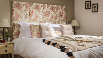 We just love the delicate floral theme throughout this bedroom...