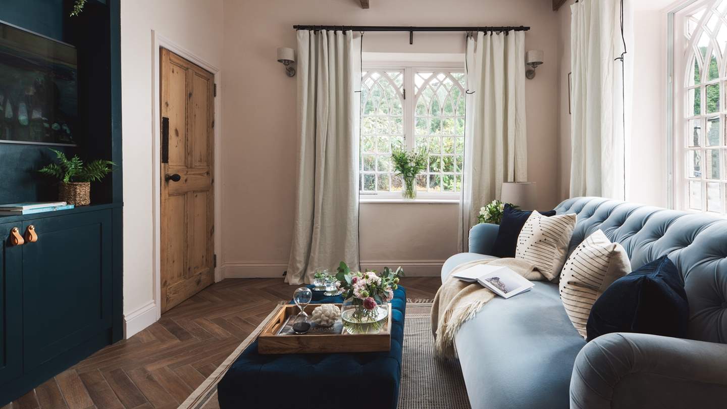 We just love the blue velvet sofa and the incredible vintage windows
