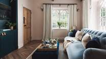We just love the blue velvet sofa and the incredible vintage windows