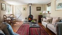 With a flickering wood burner, the cosy sitting room is the perfect spot to return to after a day's hiking on the moors