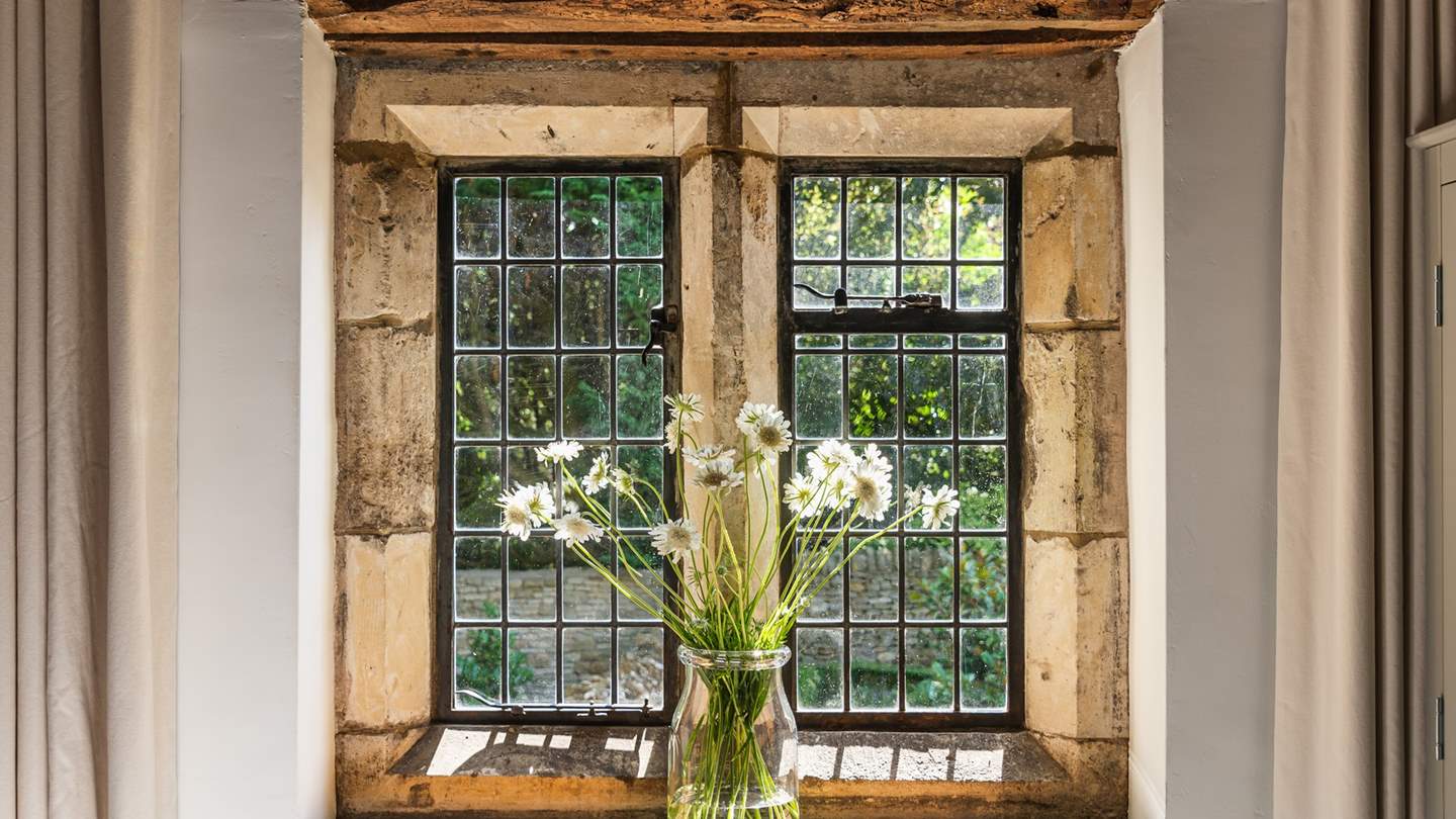 The beautiful mullioned window is a stunning feature of this bedroom