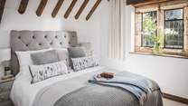 The king size bedroom has a gorgeous vaulted and beamed ceiling, making the room oh-so light and airy