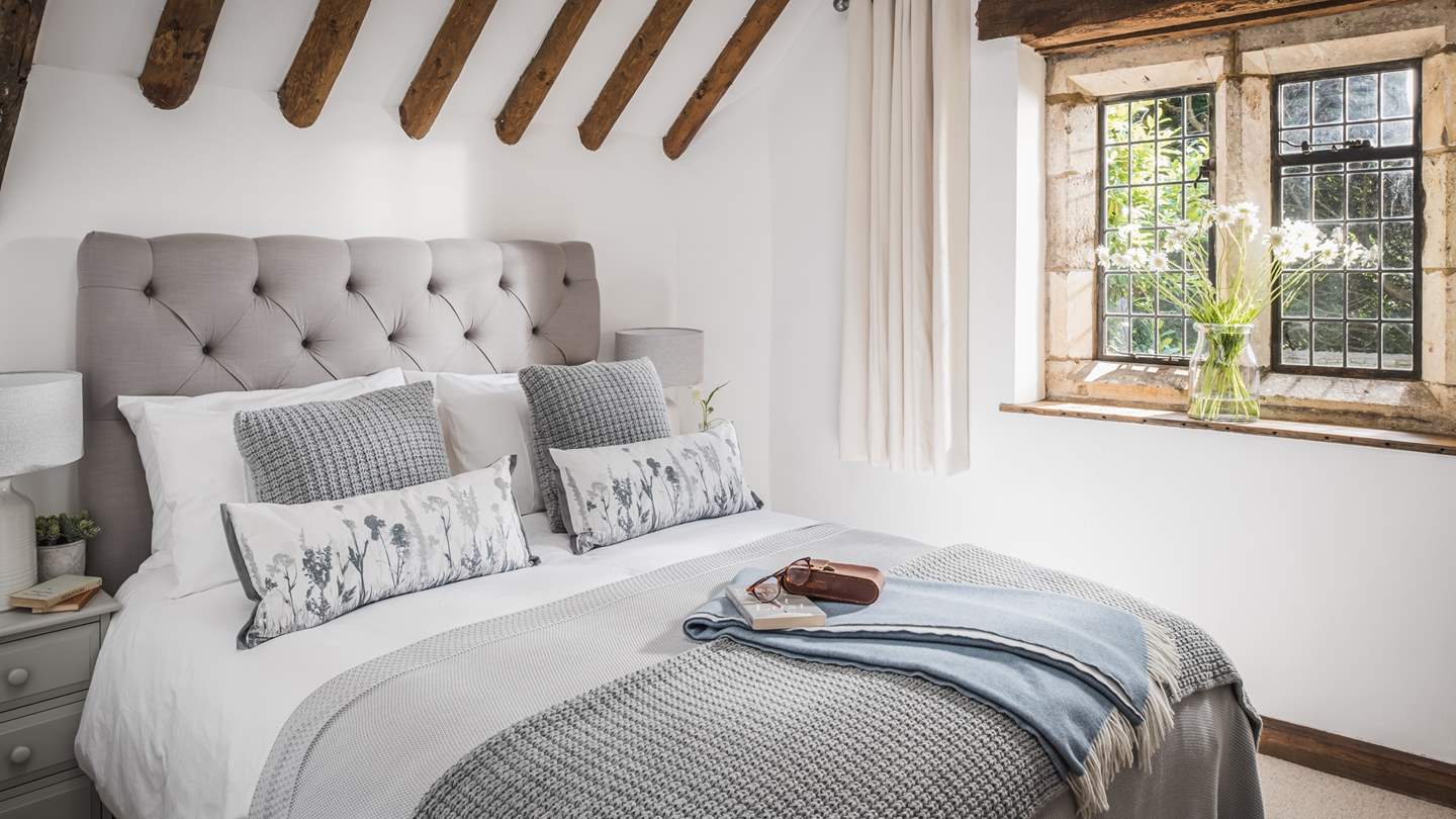 The king size bedroom has a gorgeous vaulted and beamed ceiling, making the room oh-so light and airy