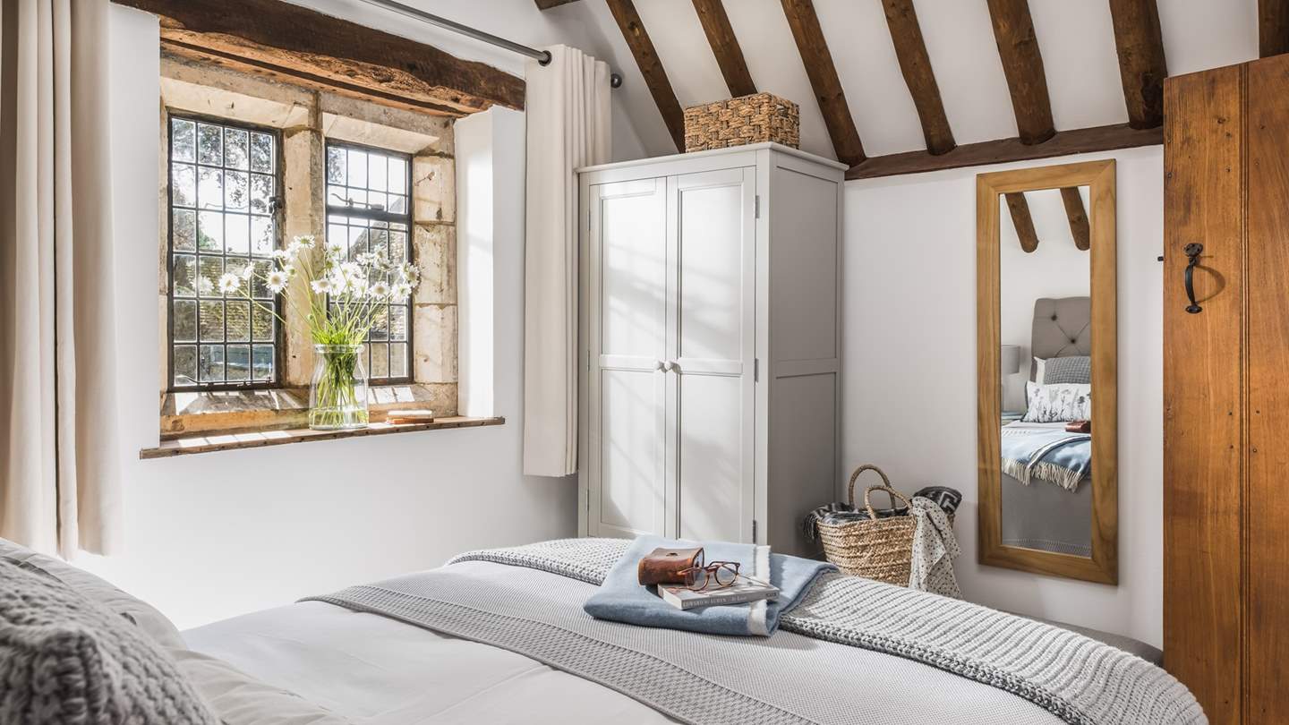 We just love the whites and soft greys used in this peaceful bedroom