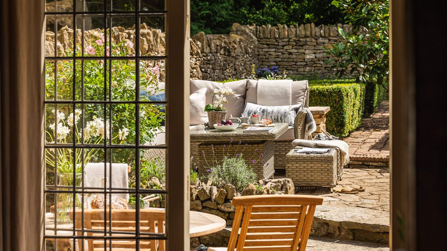 French doors lead out on to the patioed garden