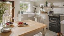 Cooking is a dream in the wonderful country kitchen, with pristine white quartz worktops, Belfast sink, and dove grey cupboards