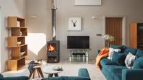 Step into a modern open plan living area, complete with a cosy wood burning stove 