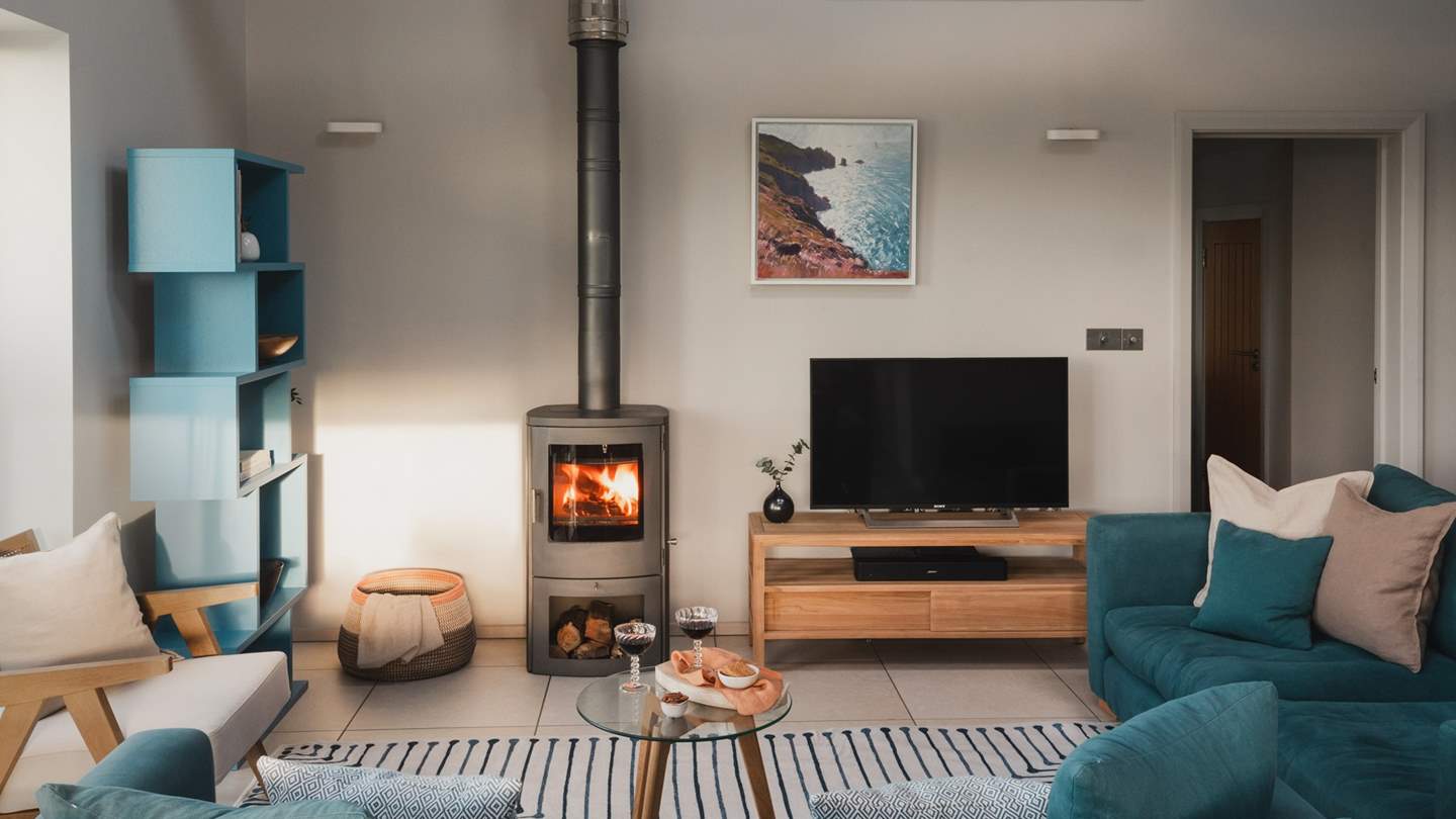 Cosy up in front of the handsome wood-burner on the sumptuous sofas dressed in a soothing shade of blue 