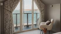 French doors lead out from here to a decked balcony which overlooks Sennen Cove, with beautiful views over towards Cape Cornwall

