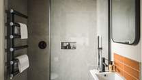 Fika holds a Lusso stone charcoal-black rainfall shower for rejuvenating soaks...