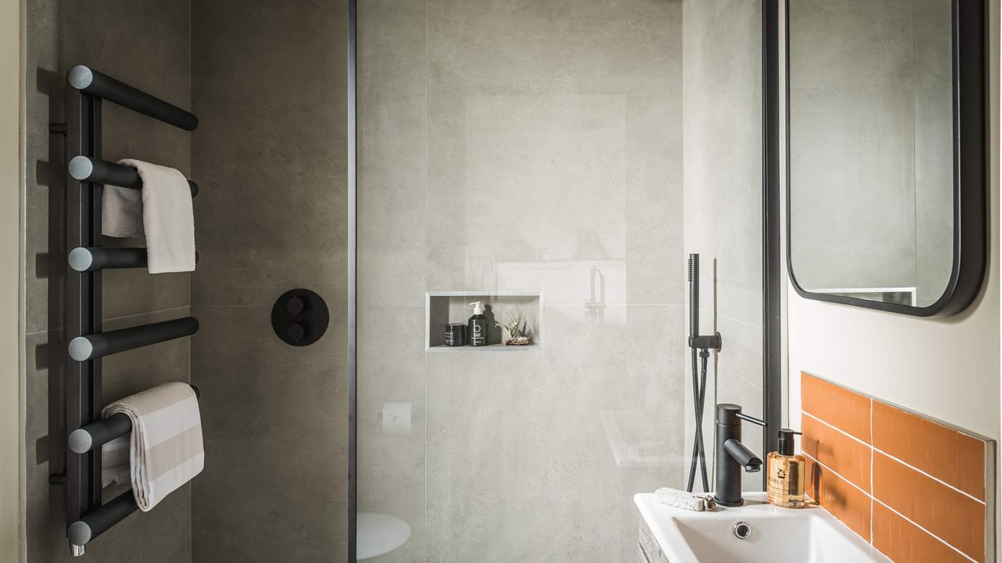 Fika holds a Lusso stone charcoal-black rainfall shower for rejuvenating soaks...