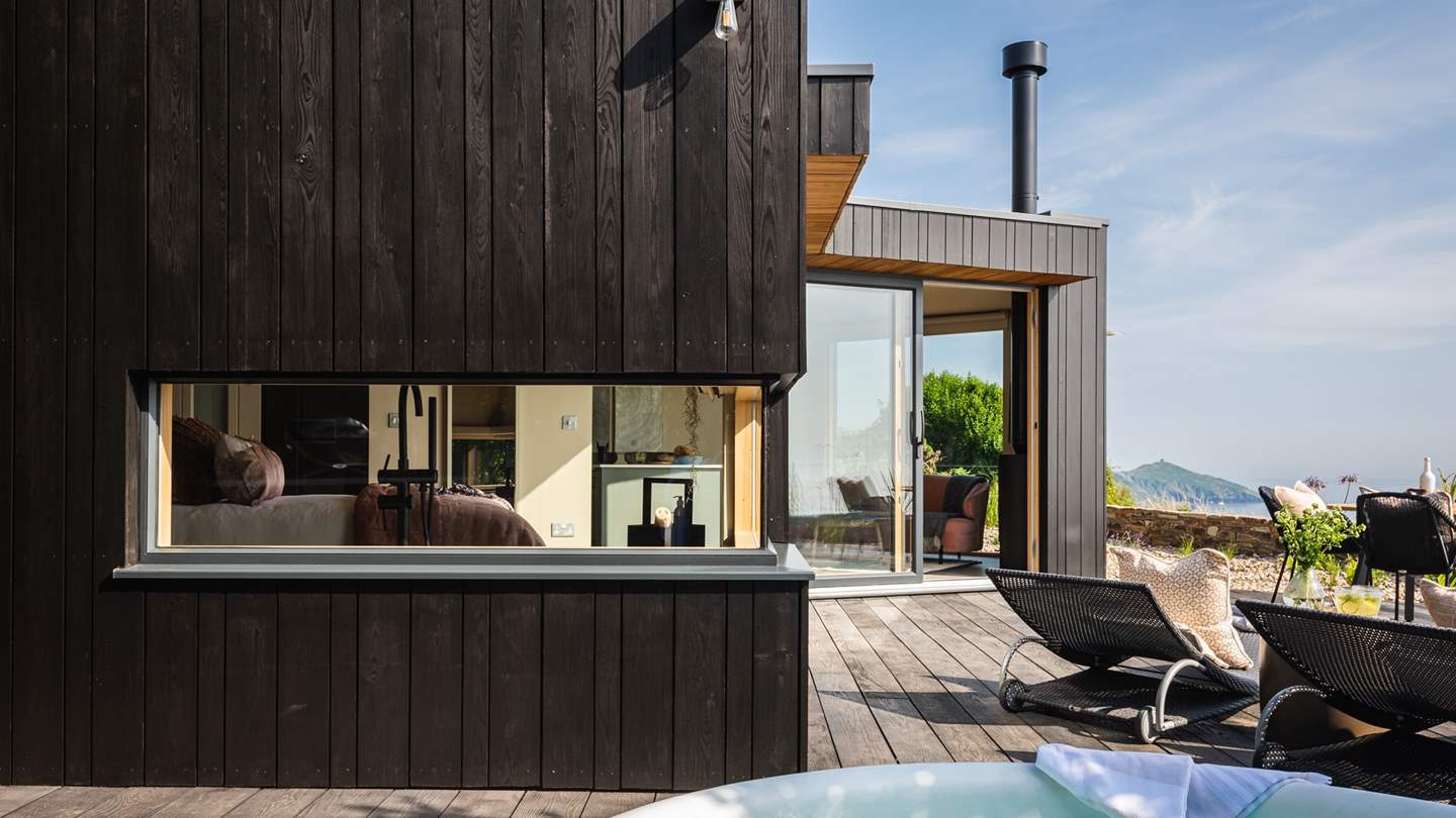 Head out onto the deck through the French door to bask in dramatic seascapes over the far-reaching horizon...