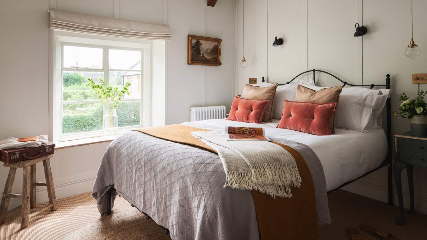One of the beautiful bedrooms, we just love the wood panelled walls and wrought iron bed