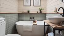 The beautiful bathroom comes complete with a freestanding bathtub, whilst there's a separate shower too...