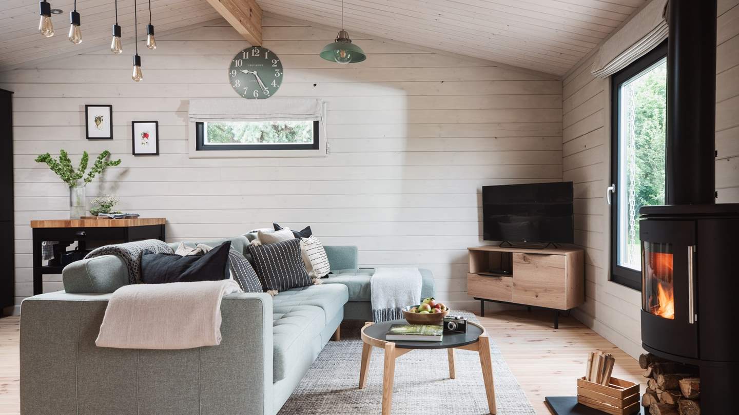 The pretty sitting area with flickering wood burner and gorgeous country views