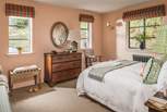 Dual aspect windows offer plenty of light into this pretty bedroom