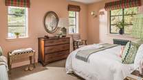 Dual aspect windows offer plenty of light into this pretty bedroom