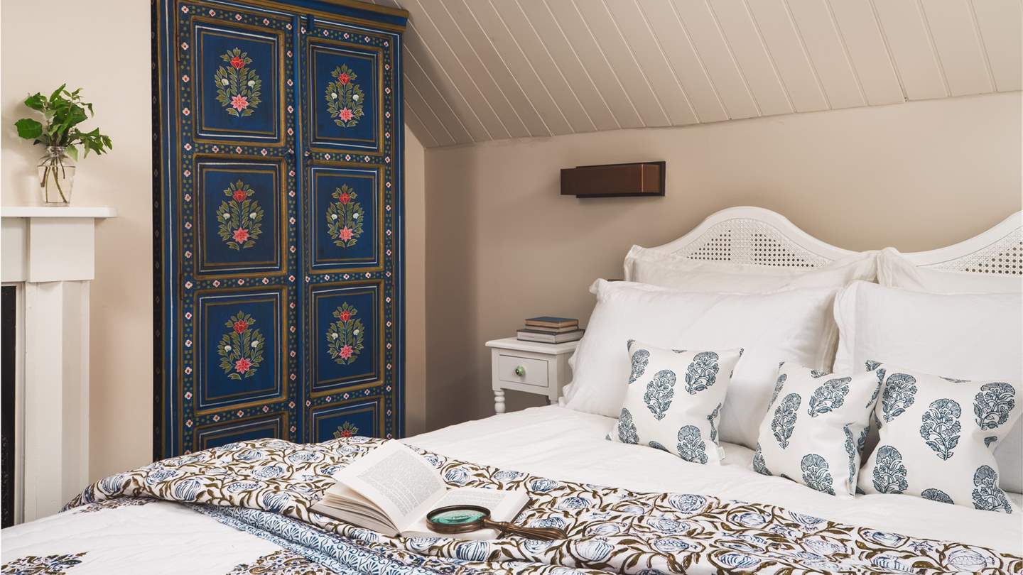 Boasting a vaulted ceiling, and colourful Indian wardrobe adding character to this charming bedroom...