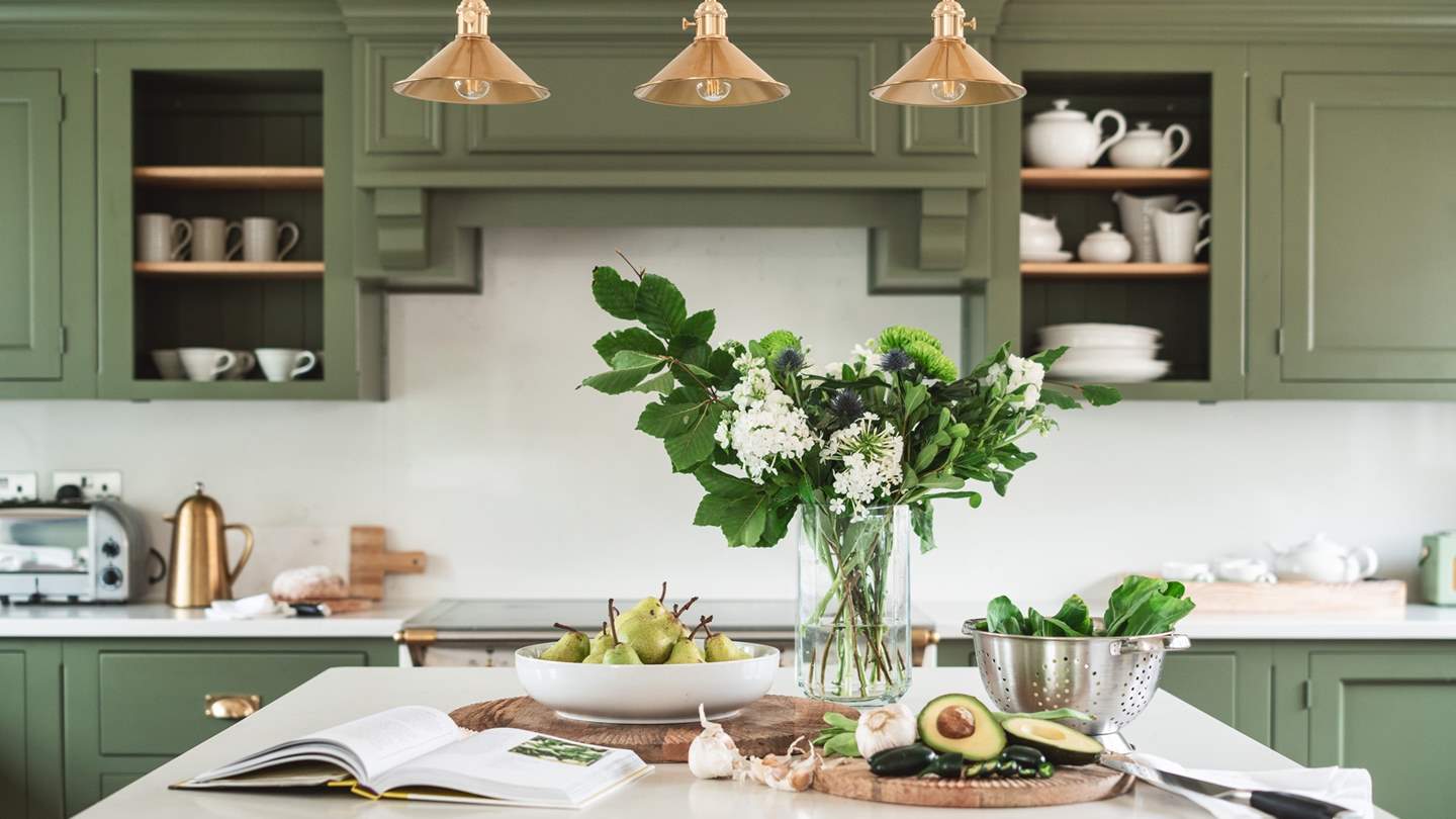 The heavenly open plan kitchen is just a dream in exquisitely natural shades of green and white...