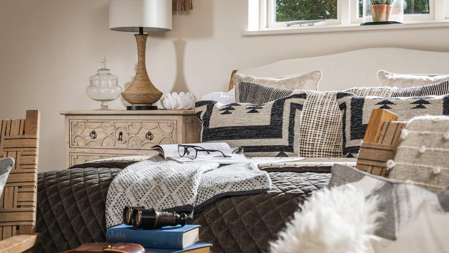 Where a lavish super king bed awaits, enveloped in soft linens, bedding, cushions and throws