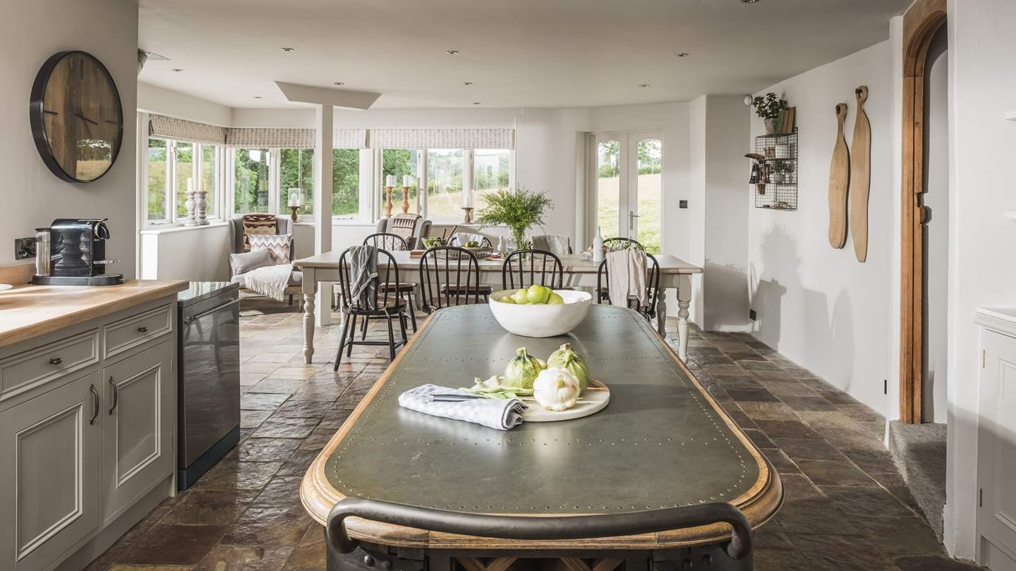 The dining space lies at the opposite end, with a large table for decadent dining