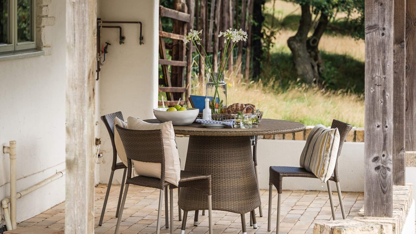 A lovely table for four ideally placed beneath the veranda for sheltered brunches under the canopy