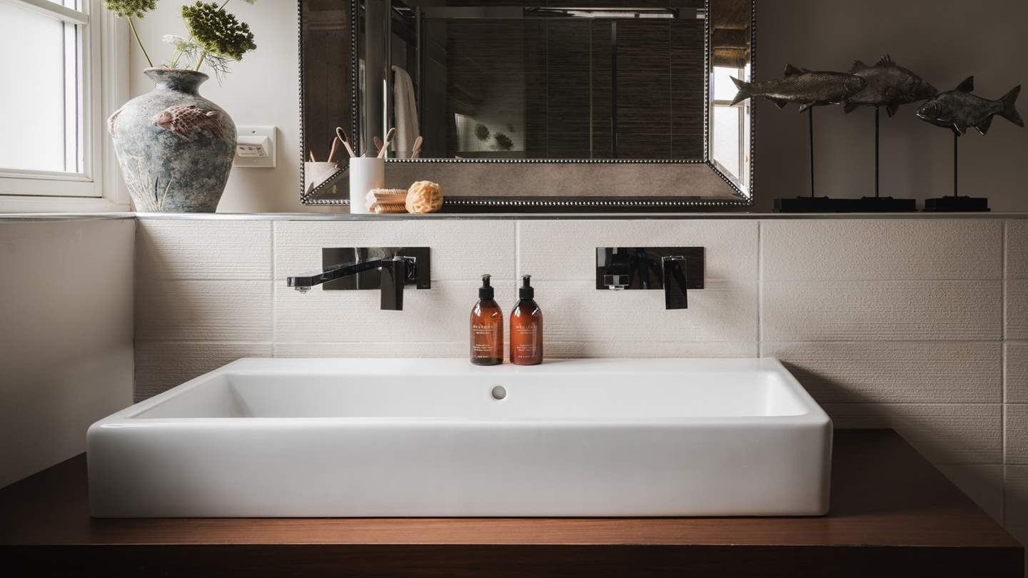 The en suite room overs a vanity sink and shower