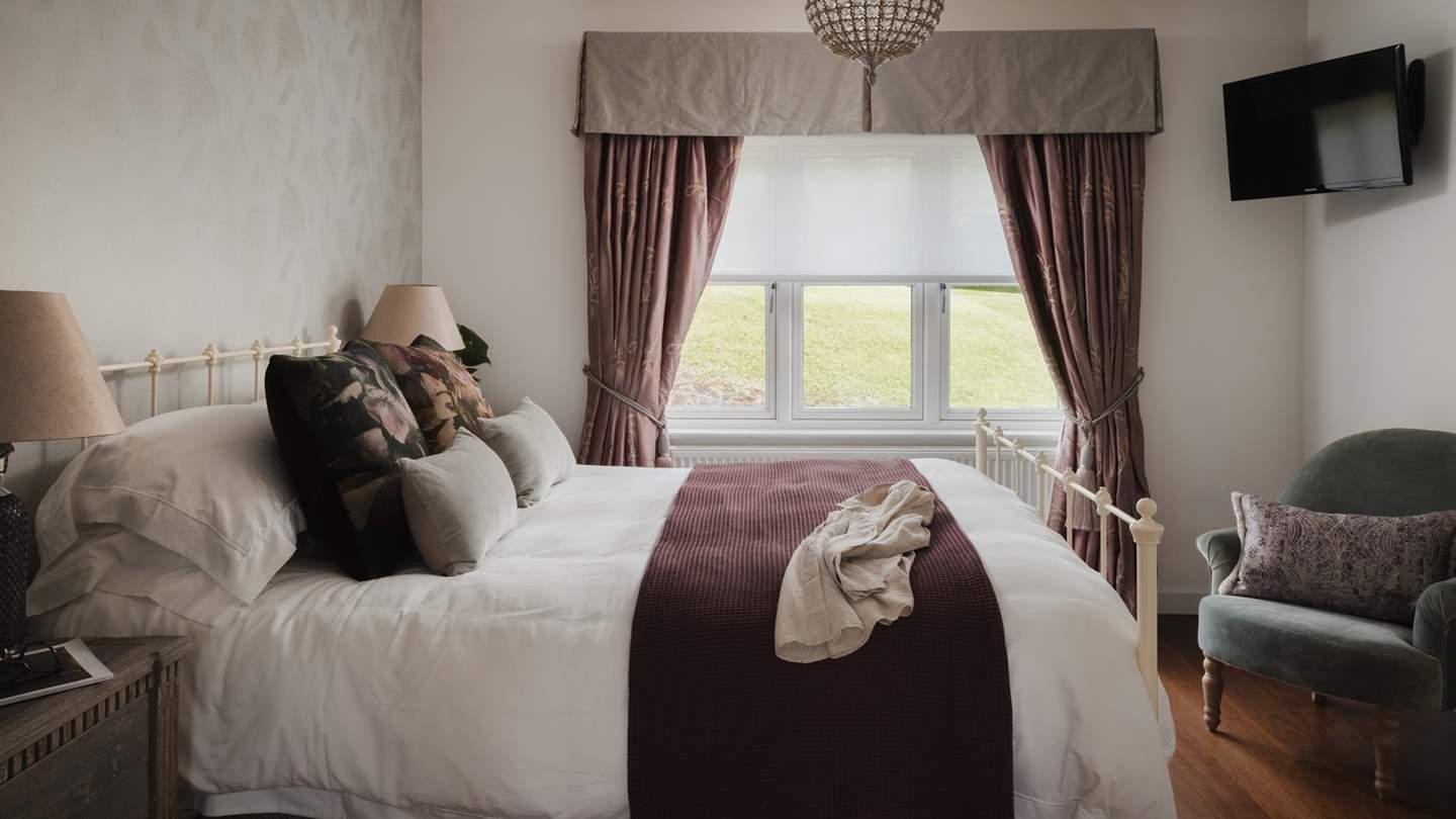 Bedroom six embraces stylish linens and chic furnishings