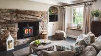 Settle in for cosy cottage moments beside the charming fireplace...
