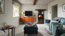 The snug sitting room is just perfect for cosying up together after a busy day exploring