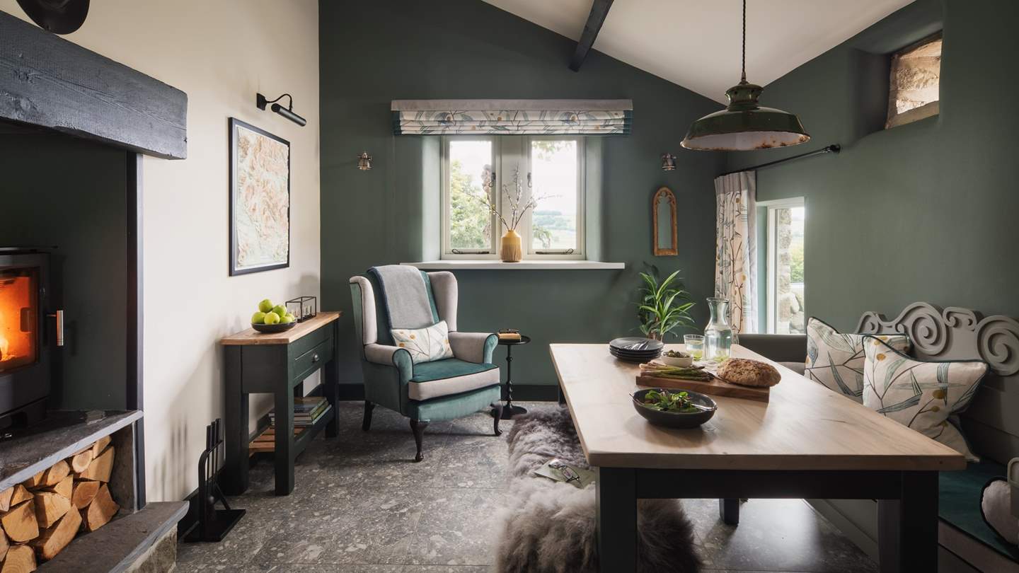 The cosy dining room for meals a deux, with flickering double-sized wood burner
