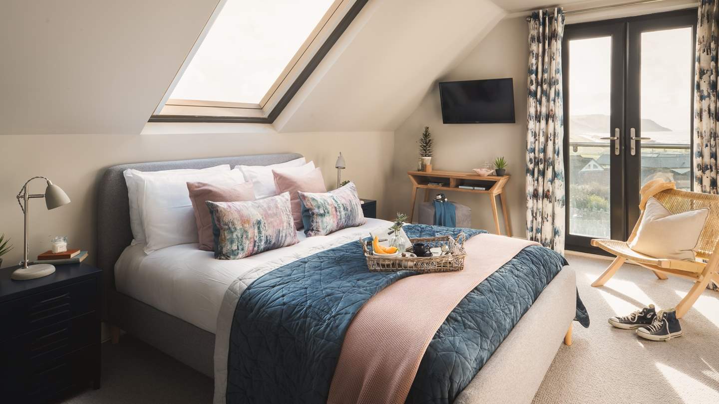 There are five chic, spacious bedrooms to choose from in this lovely seaside home