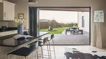 Bi-fold doors open out on to the garden with far-reaching sea views, letting in plenty of light