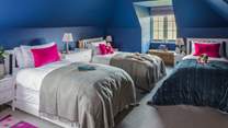 The fifth bedroom – in blues and pinks - is just perfect for little ones and has three single beds plus a trestle bed should you need it