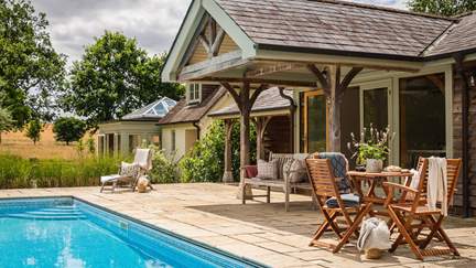 Step into the garden and you’ll discover a blissful space in which to relax, complete with a heated outdoor swimming pool 