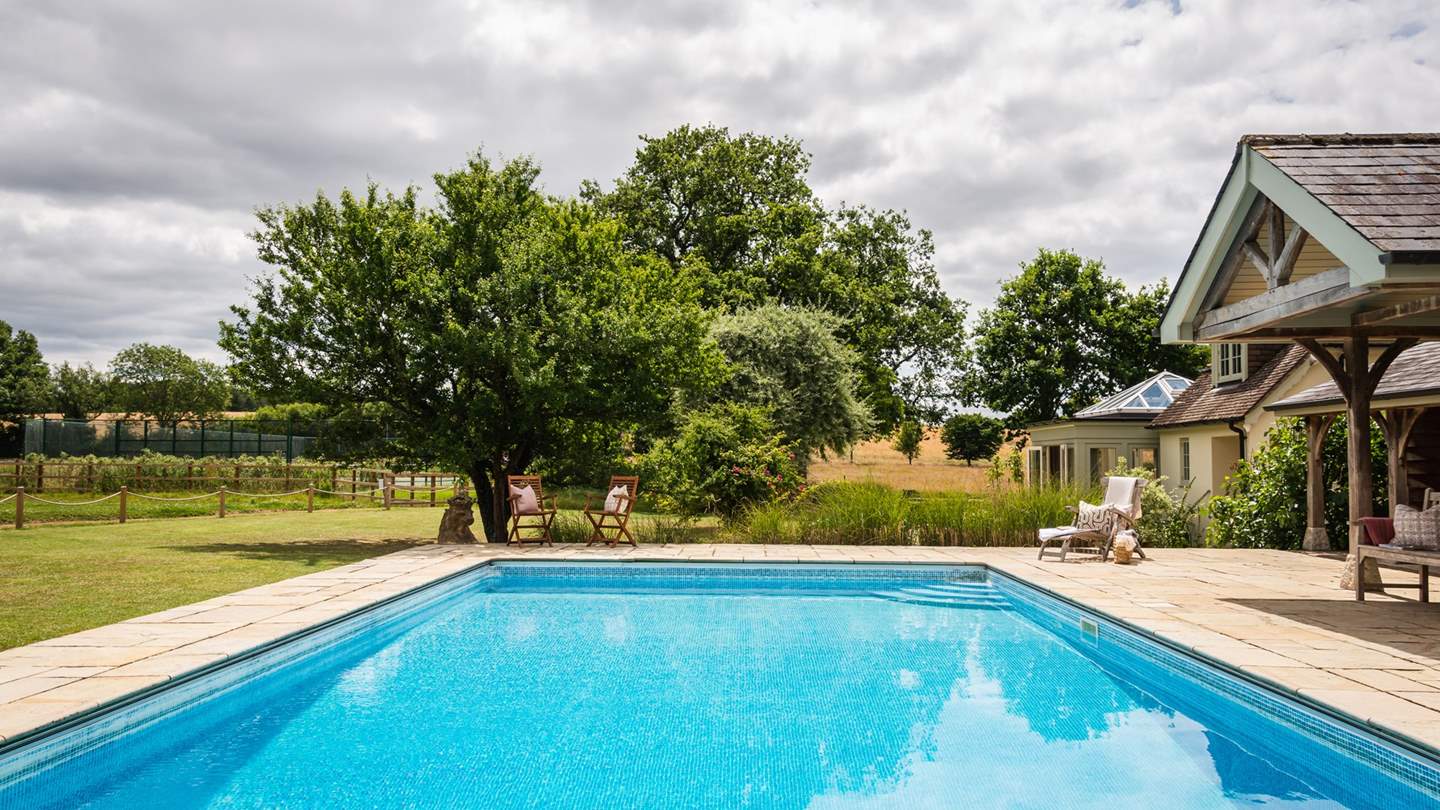 Loungers and chairs nestled around the pool offer space for everyone to relax