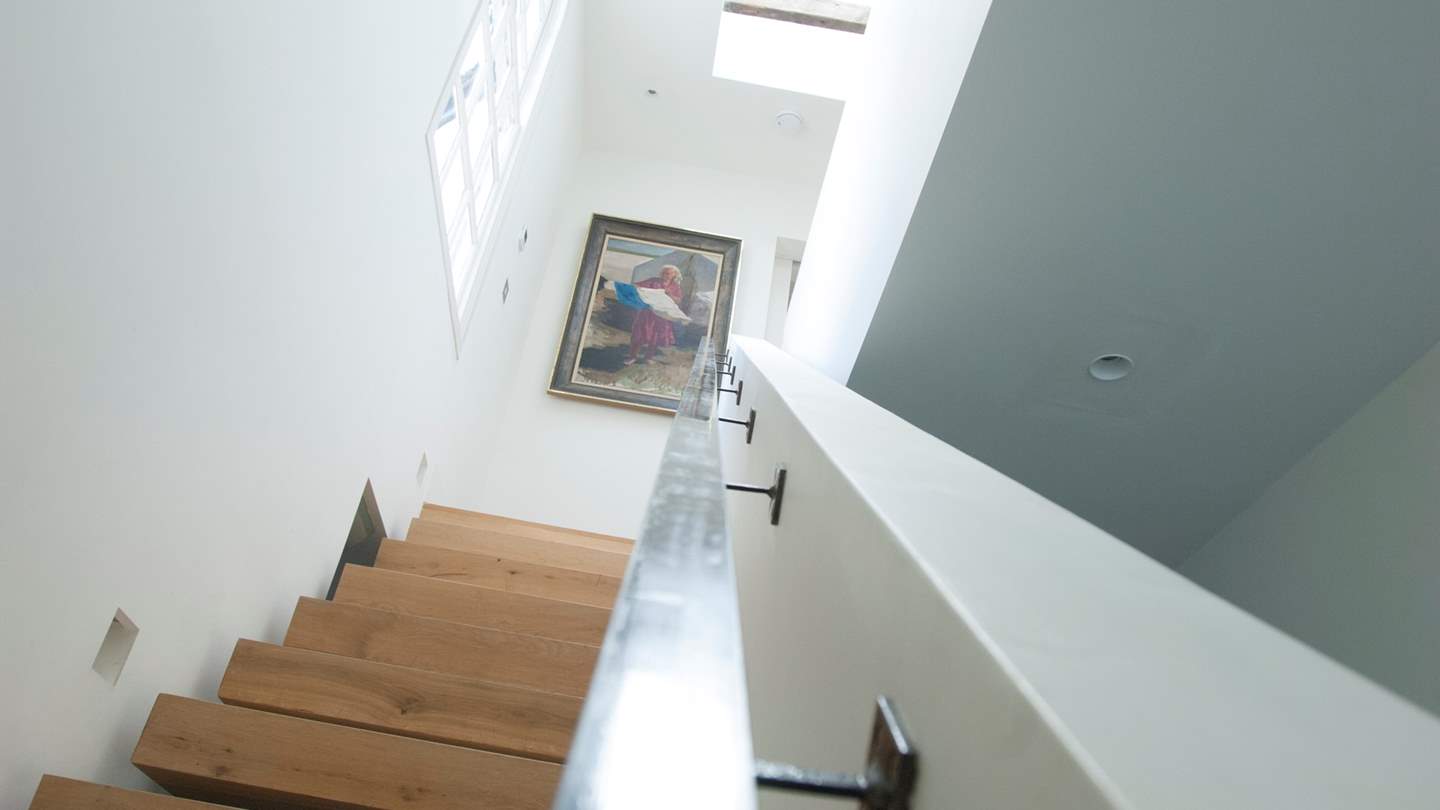 Stairs lead up to the three bedrooms and bathrooms