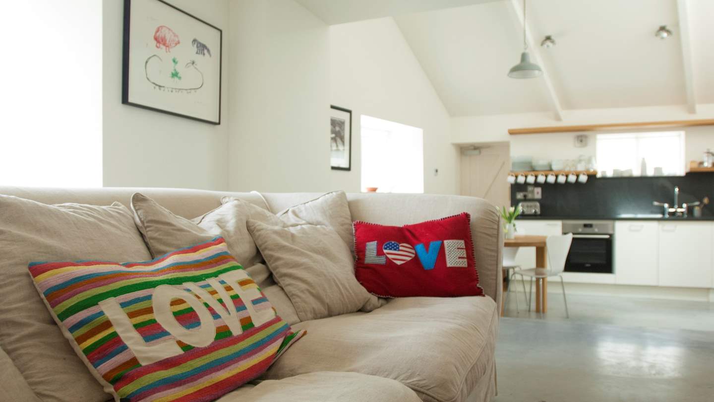The open plan living room with steps down to the kitchen/dining area