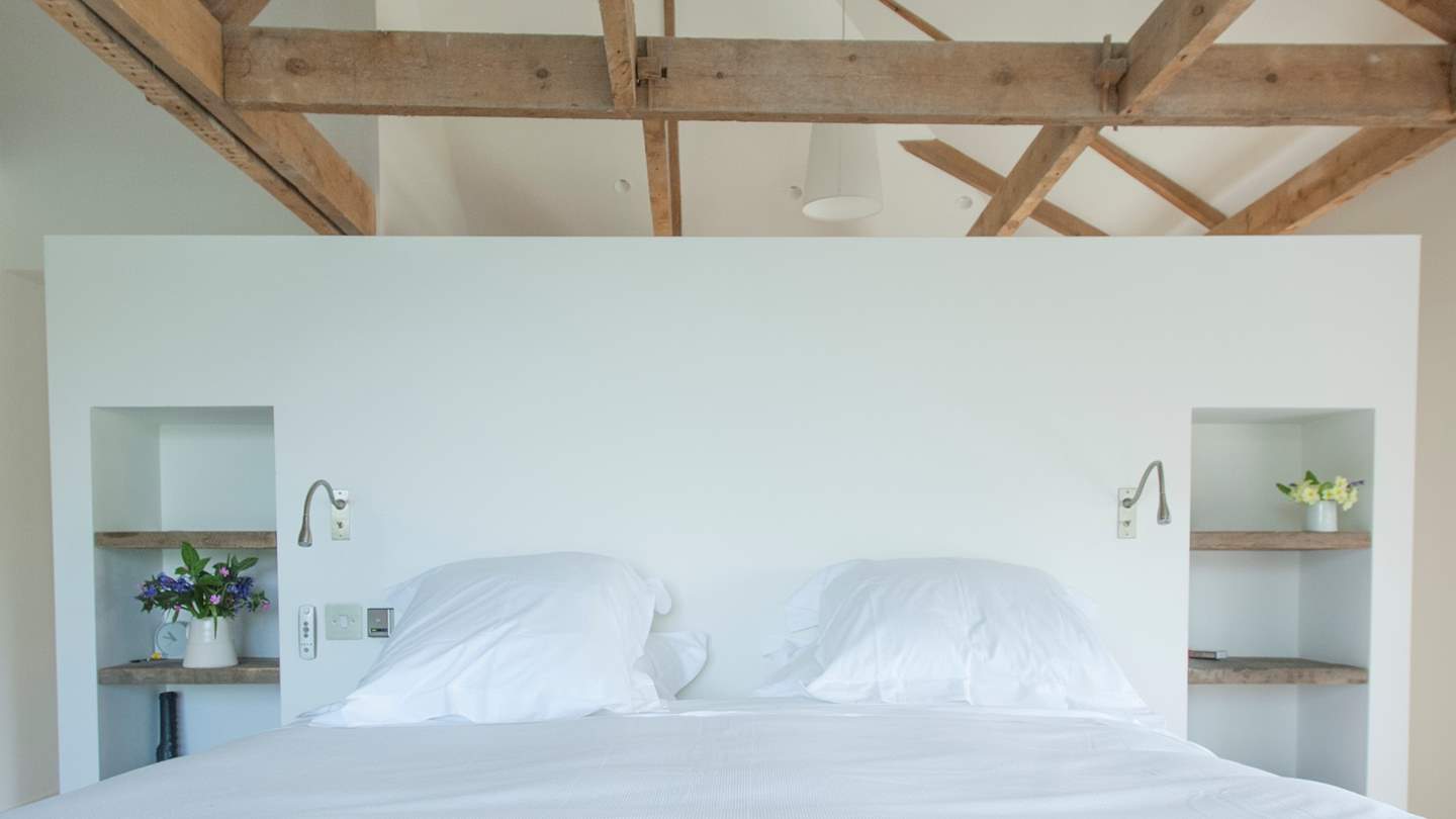 The en suite master bedroom with dressing area behind the bed...