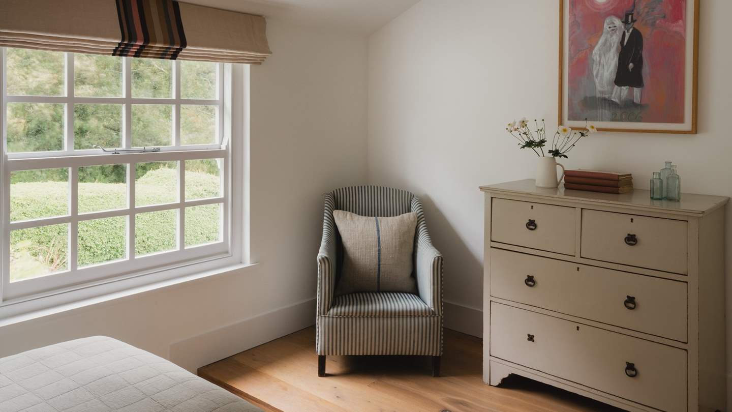 Providing space for belongings are a sweet chest of antique drawers 