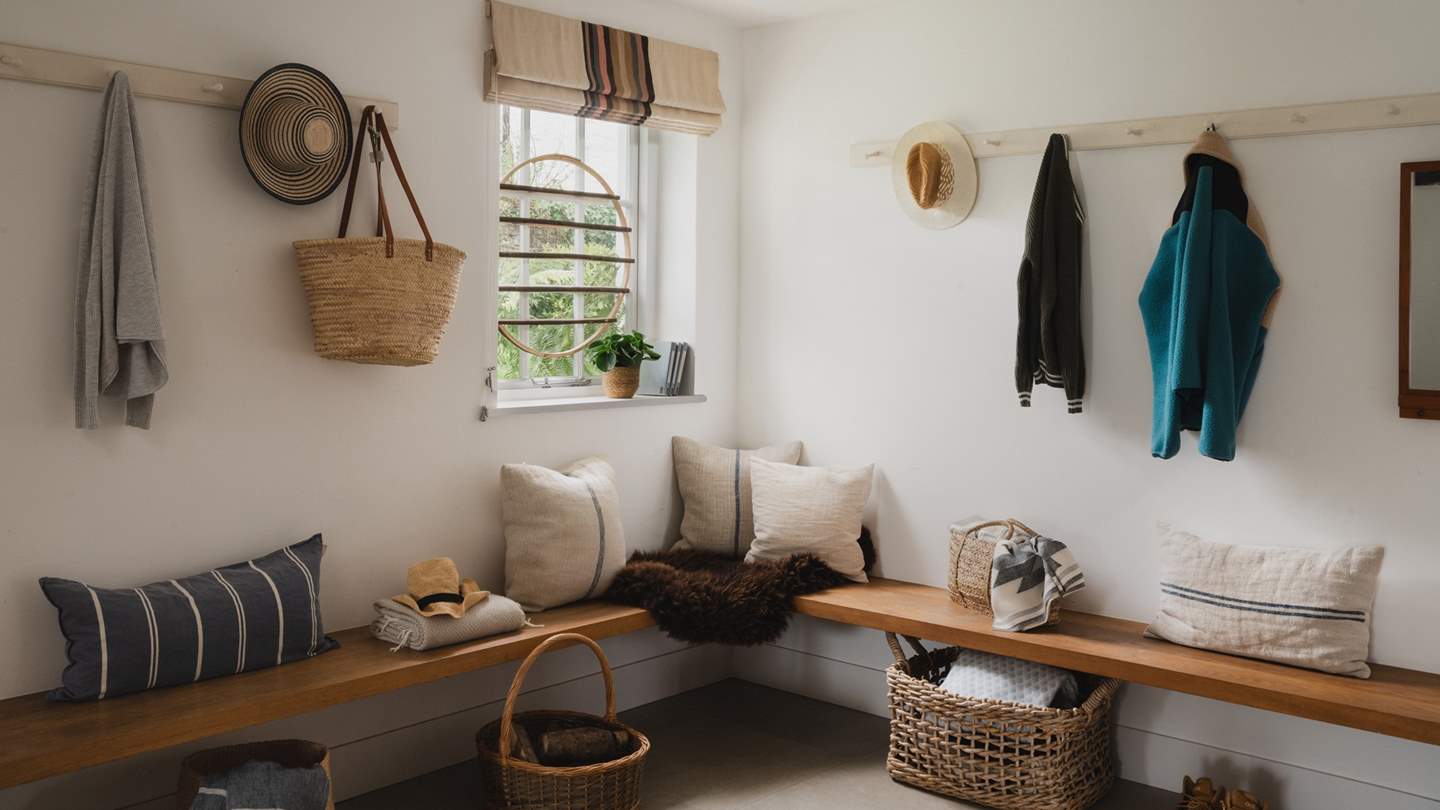The slate-floored entrance hall of The Miller's House is lined with oak benches and plenty of hooks to hang coats and bags after a day of exploring