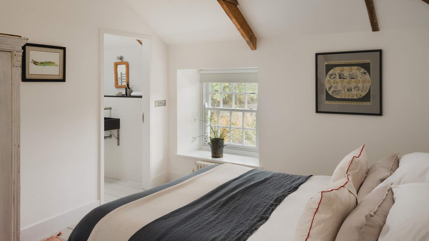 A restful repose beneath timeless exposed beams where calm staycation moments linger