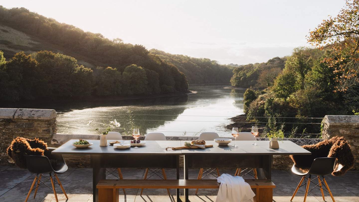 Glass doors lead out onto the terrace which directly overlooks the creek that comes up to Froe's private quay
