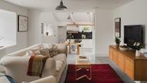 Uncover the open plan living room with steps down to the kitchen and dining space