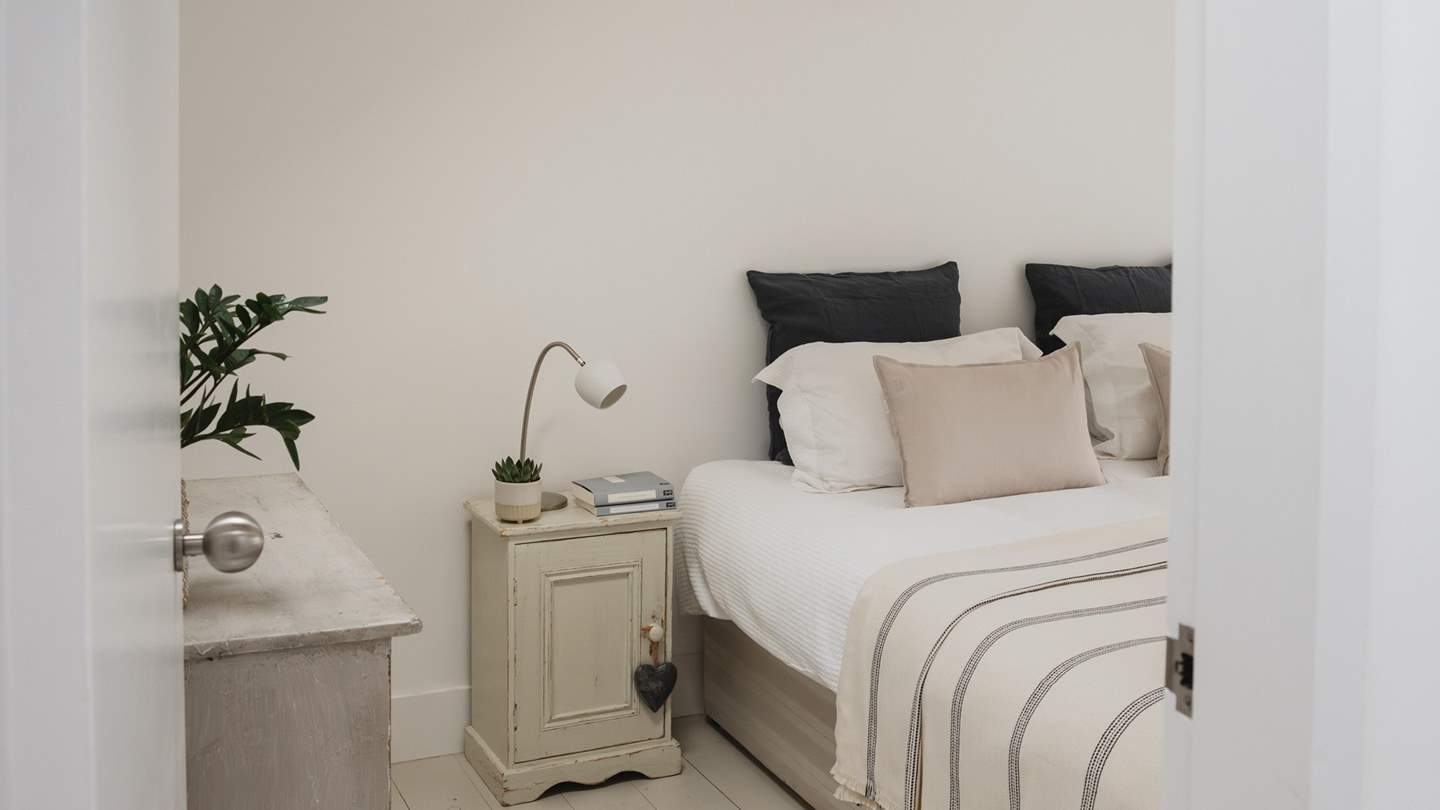 The first double bedroom invites for blissful slumber, dressed in soothing neutral tones